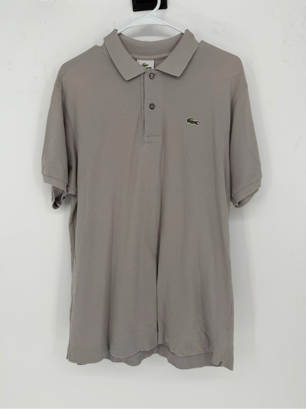 Lacoste polo shirt in a light gray color with a signature green crocodile logo